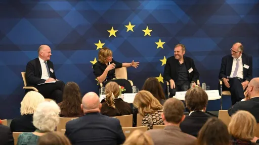 Event stage at Taste of Europe event, panelists sitting in front of the EU emblem